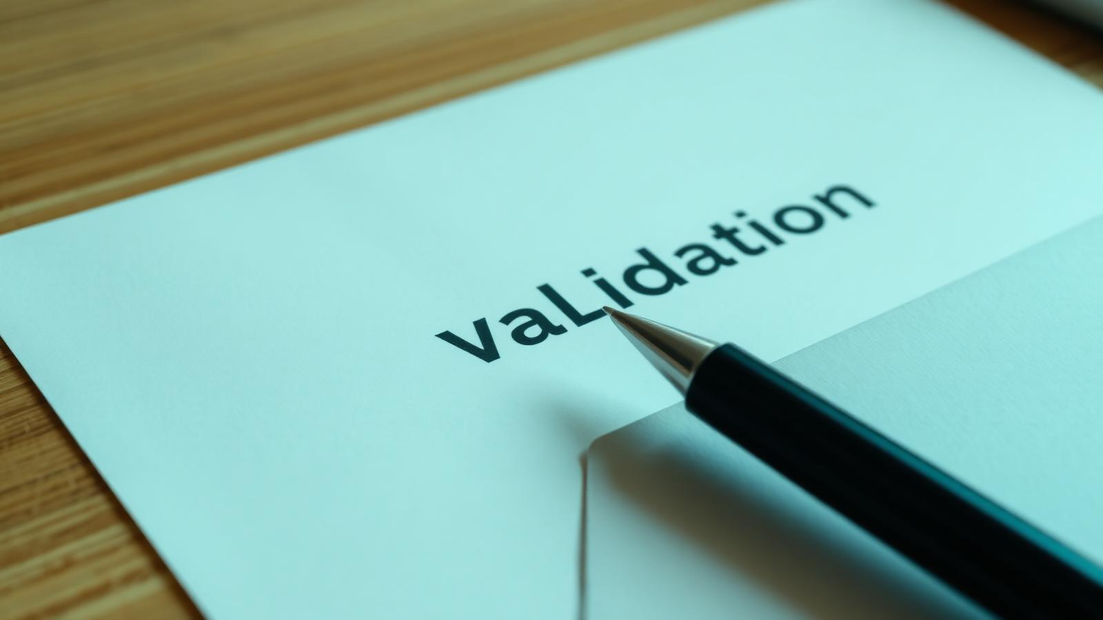 Printed debt validation letter on a desk with a pen and envelope